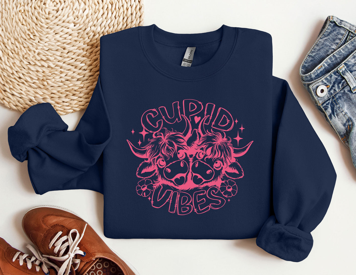 a blue sweatshirt with a pink graphic on it