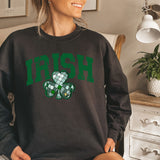 a woman sitting on a bed wearing a sweatshirt