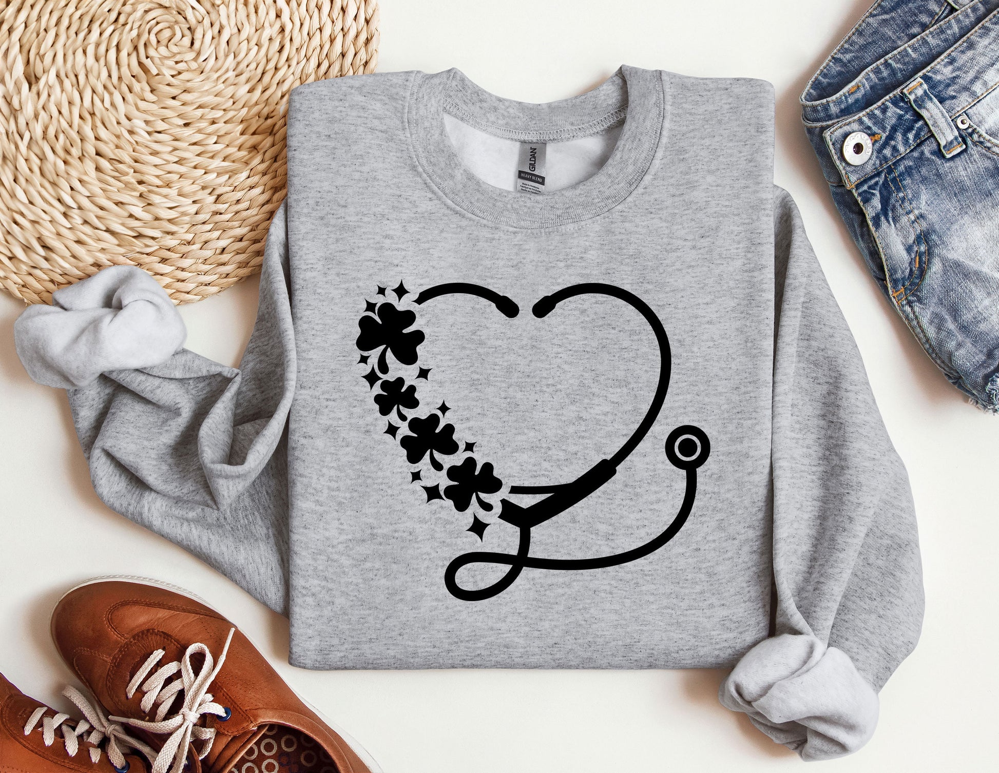 a sweater with a stethoscope and flowers on it