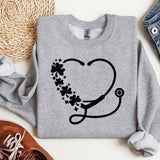 a sweater with a stethoscope and flowers on it