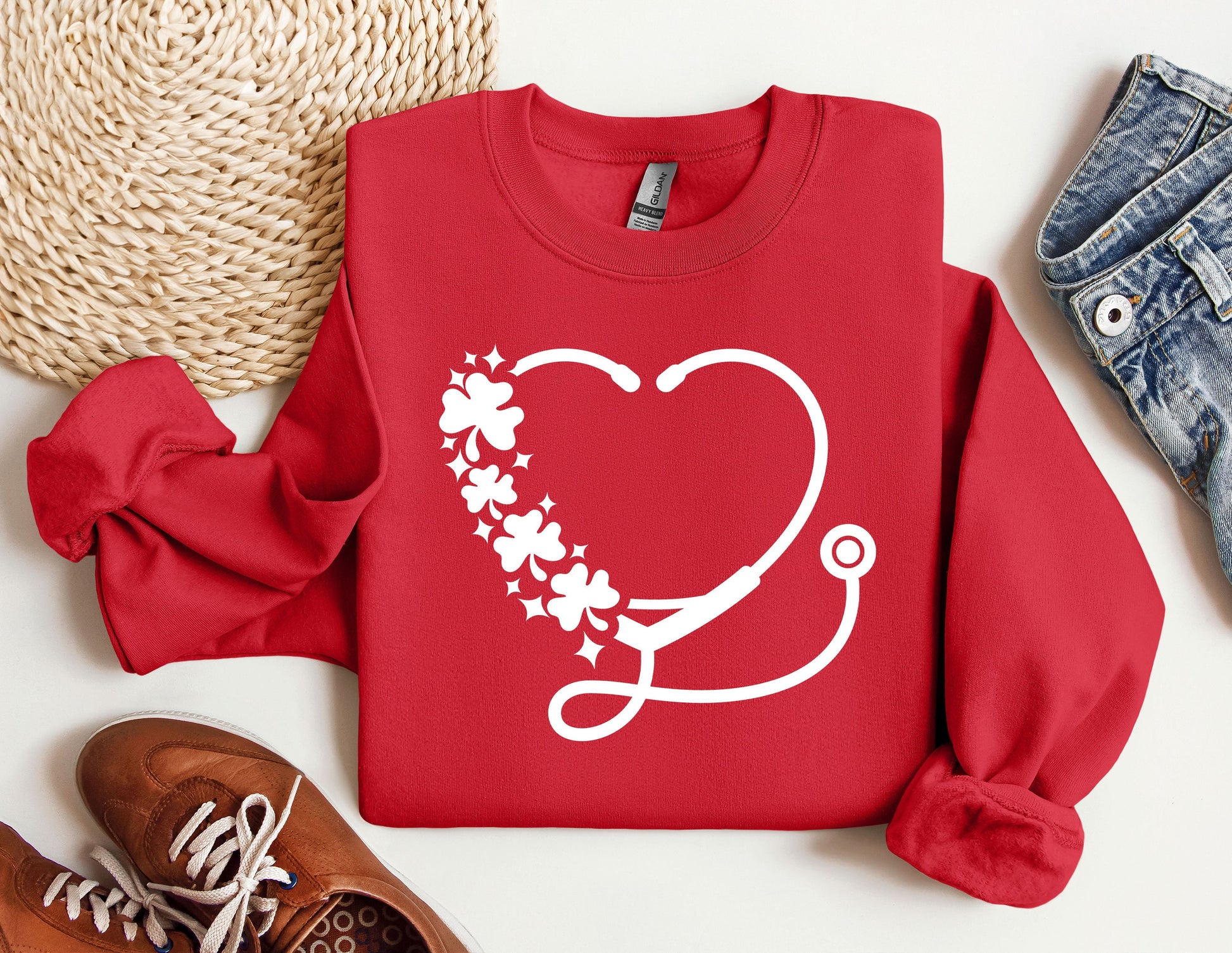 a red sweater with a stethoscope and flowers on it