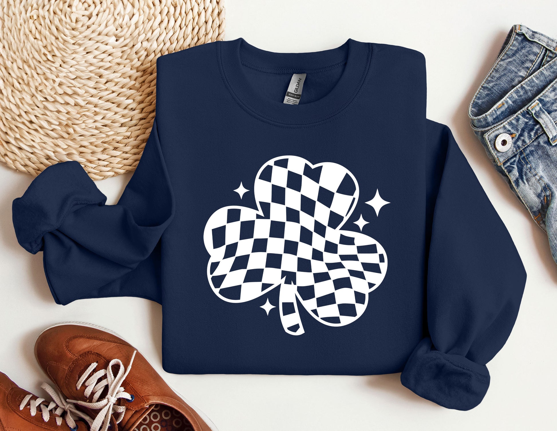 a blue sweater with a four leaf clover on it