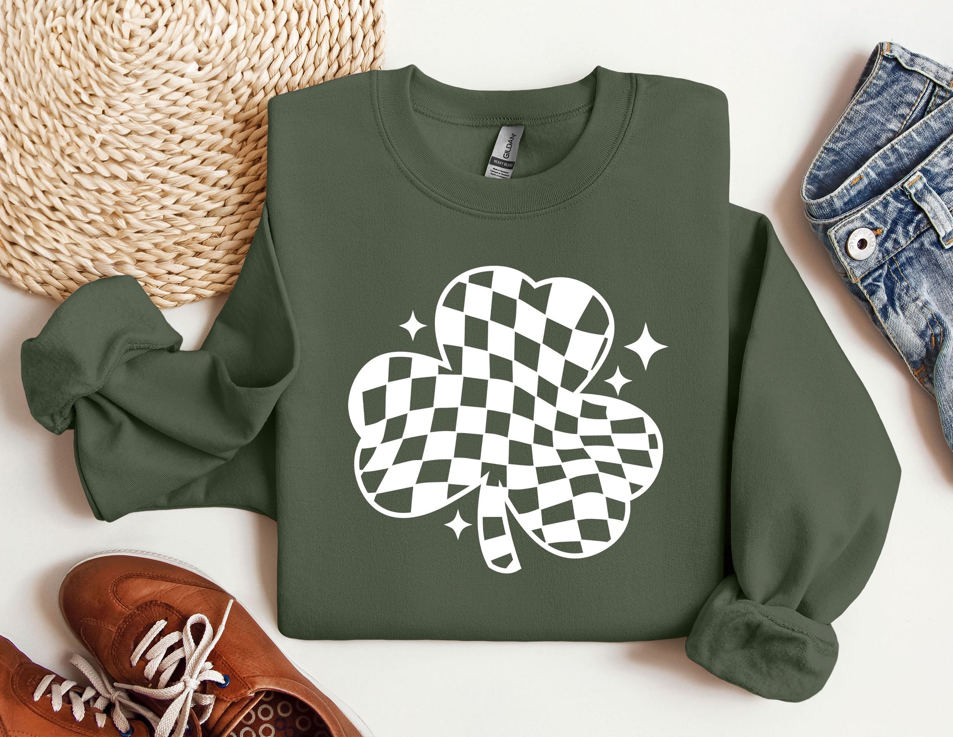 a green sweatshirt with a four leaf clover on it
