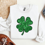 a white shirt with a green shamrock on it