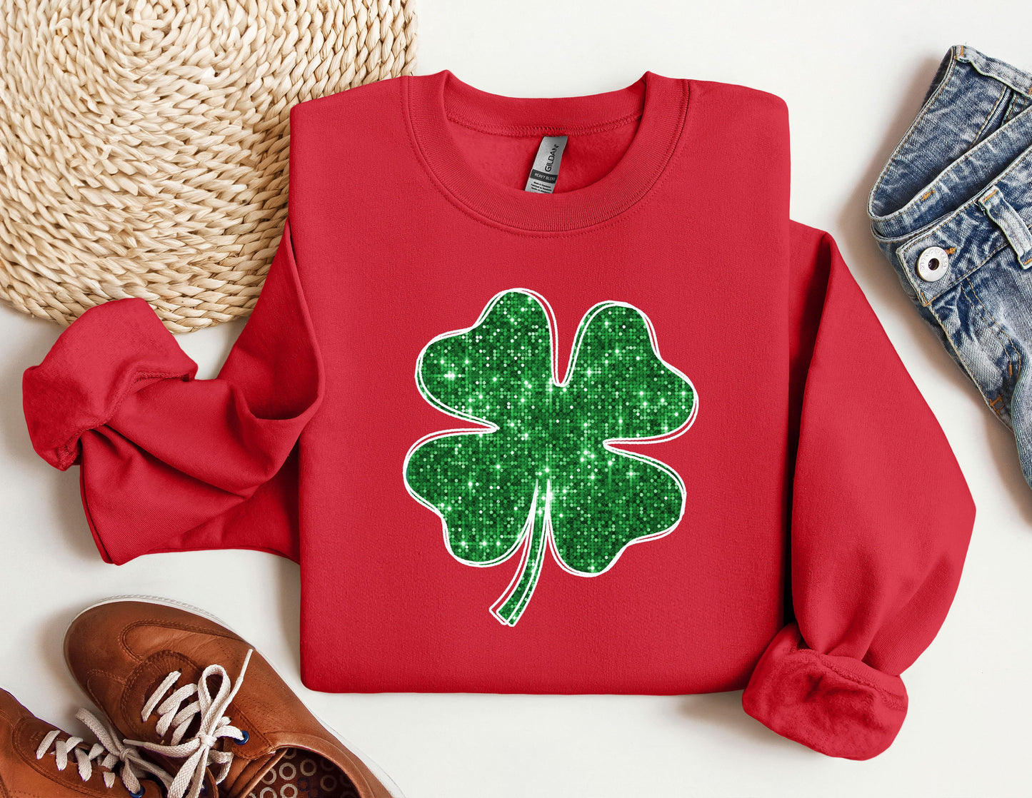 a red sweater with a green shamrock on it