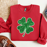 a red sweater with a green shamrock on it