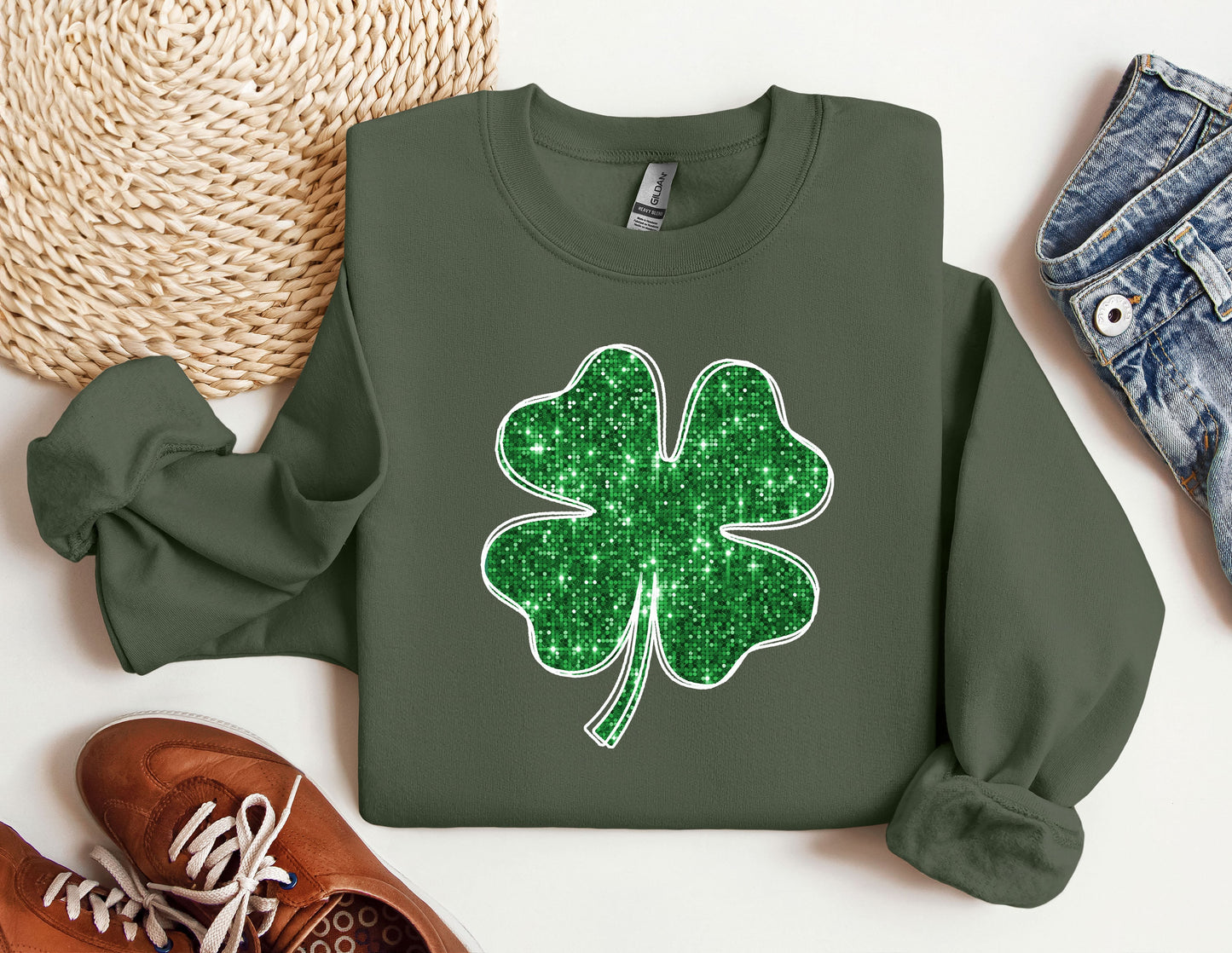 a green sweatshirt with a four leaf clover on it