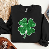 a black sweater with a green shamrock on it