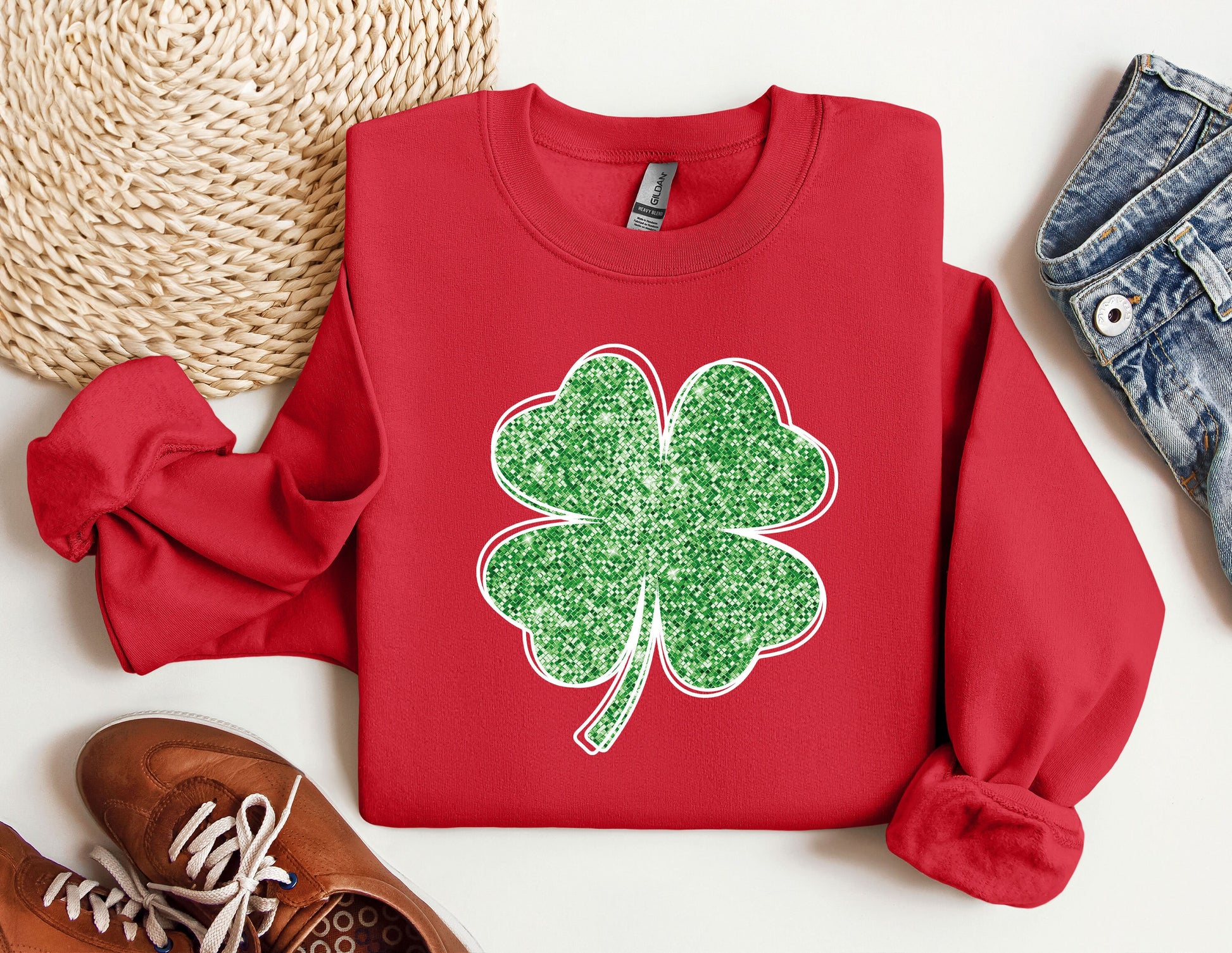 a red sweater with a green clover on it