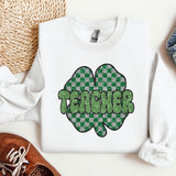 a white shirt with a green shamrock on it