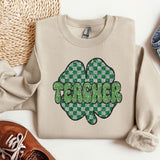 a pair of shoes and a sweater with a shamrock on it