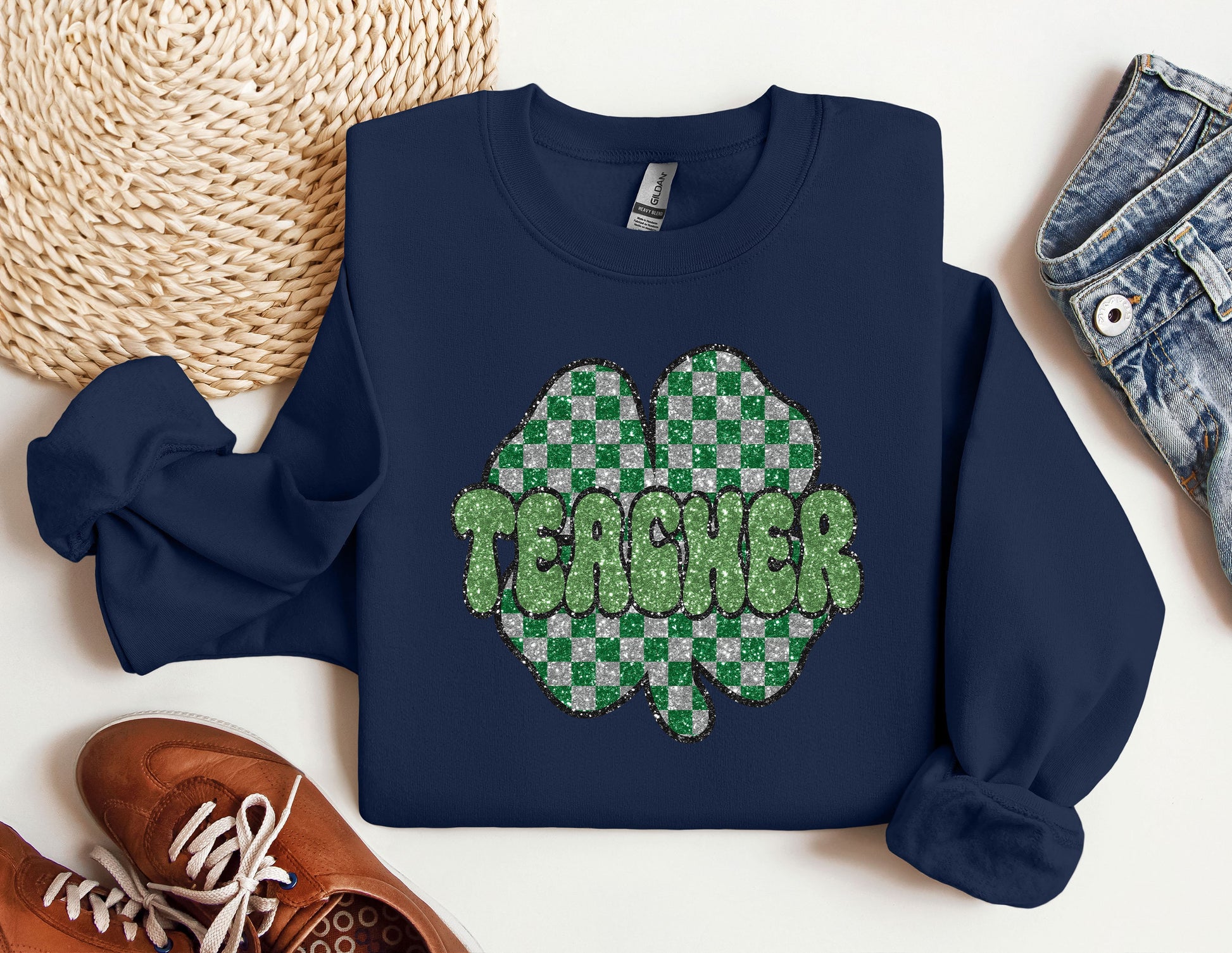 a blue sweatshirt with a green shamrock on it