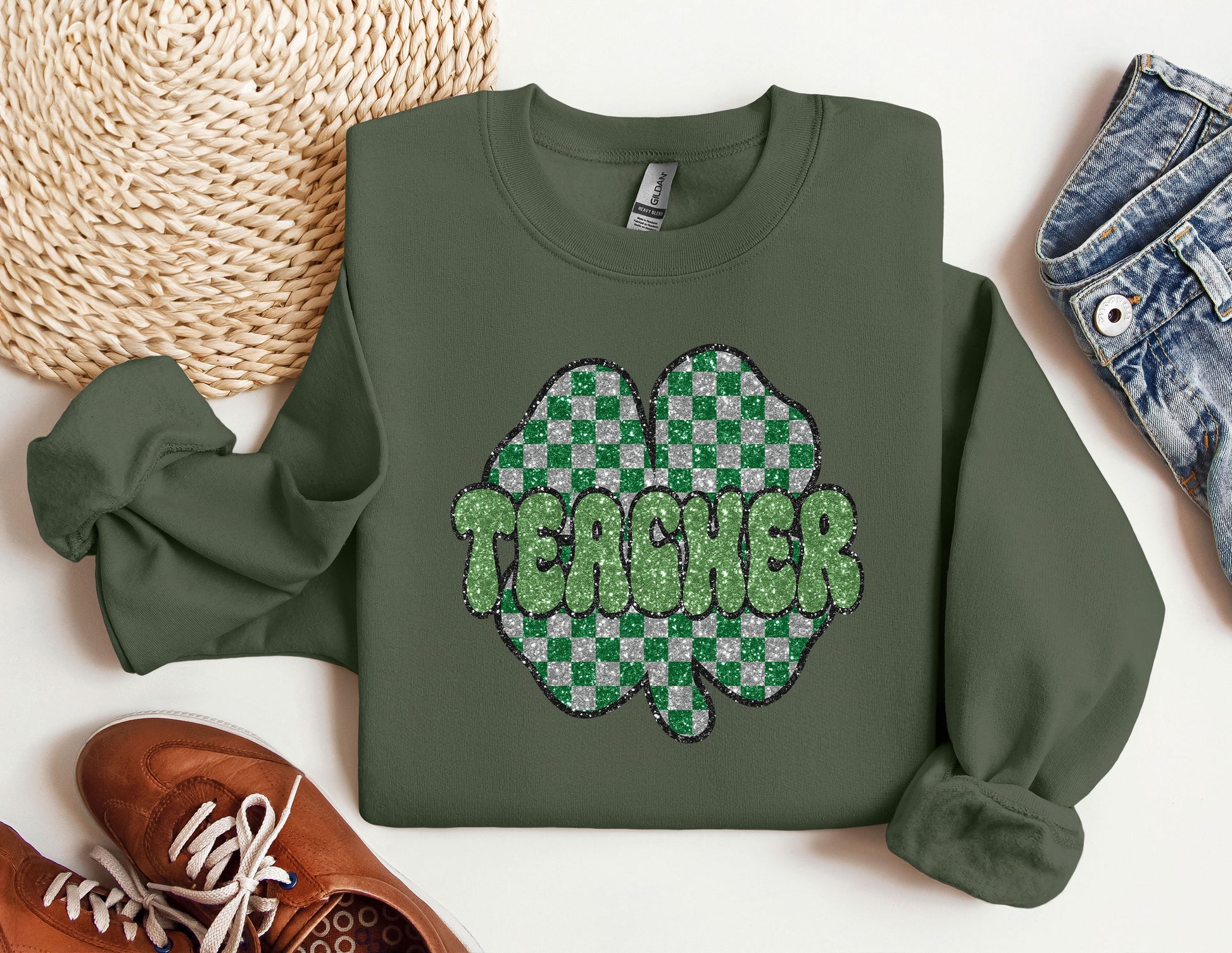 a green sweatshirt with the words teacher on it