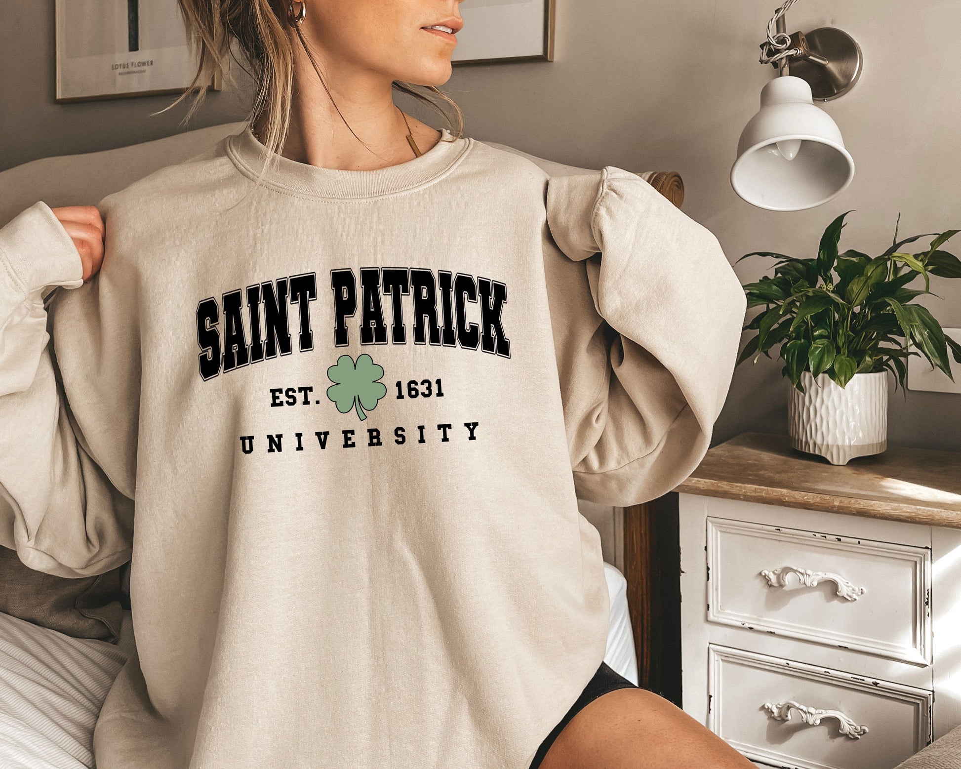 a woman wearing a sweatshirt that says saint patrick