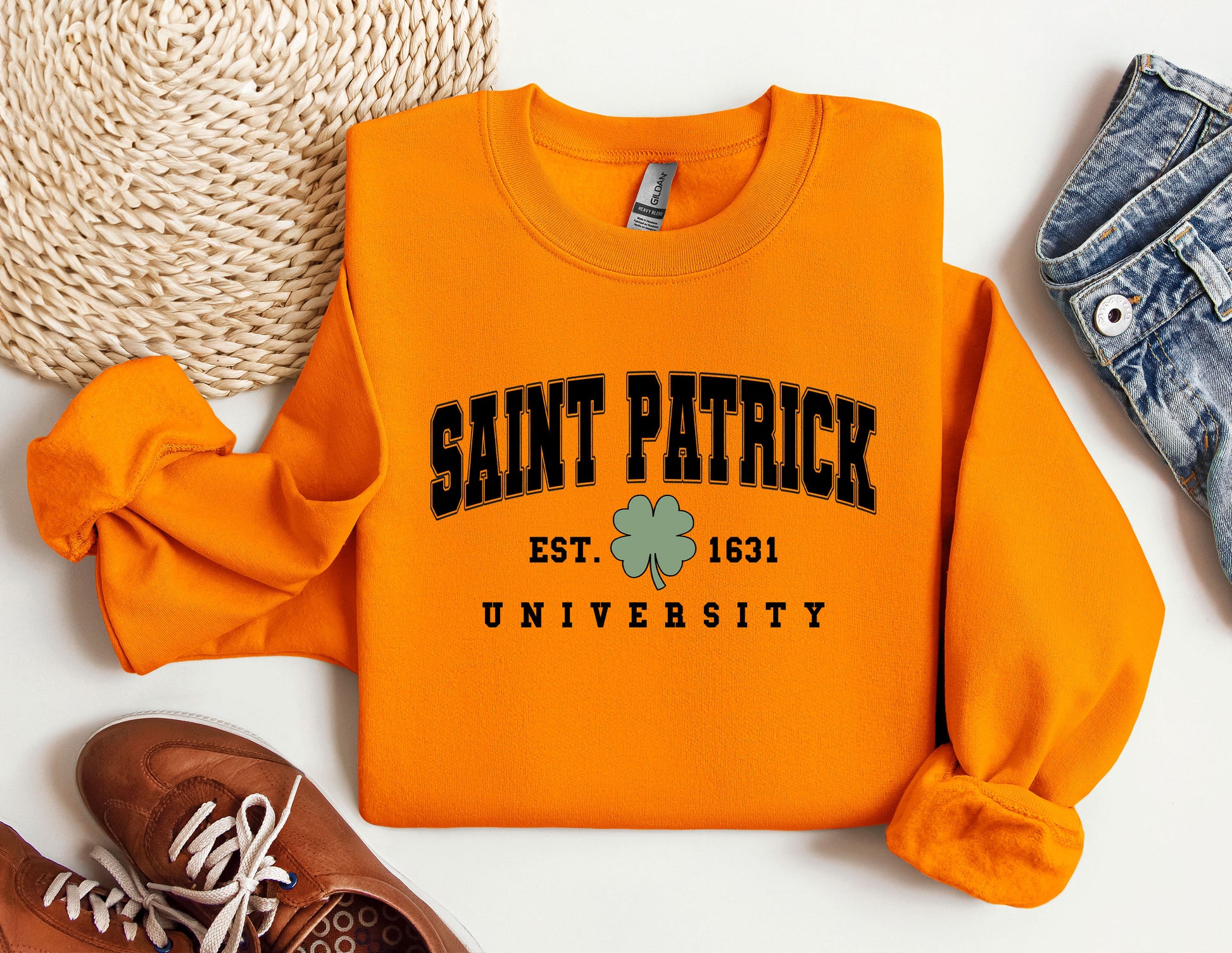 an orange sweatshirt with saint patrick on it next to a pair of shoes