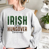 a woman wearing a sweatshirt that says irish today hungover tomorrow