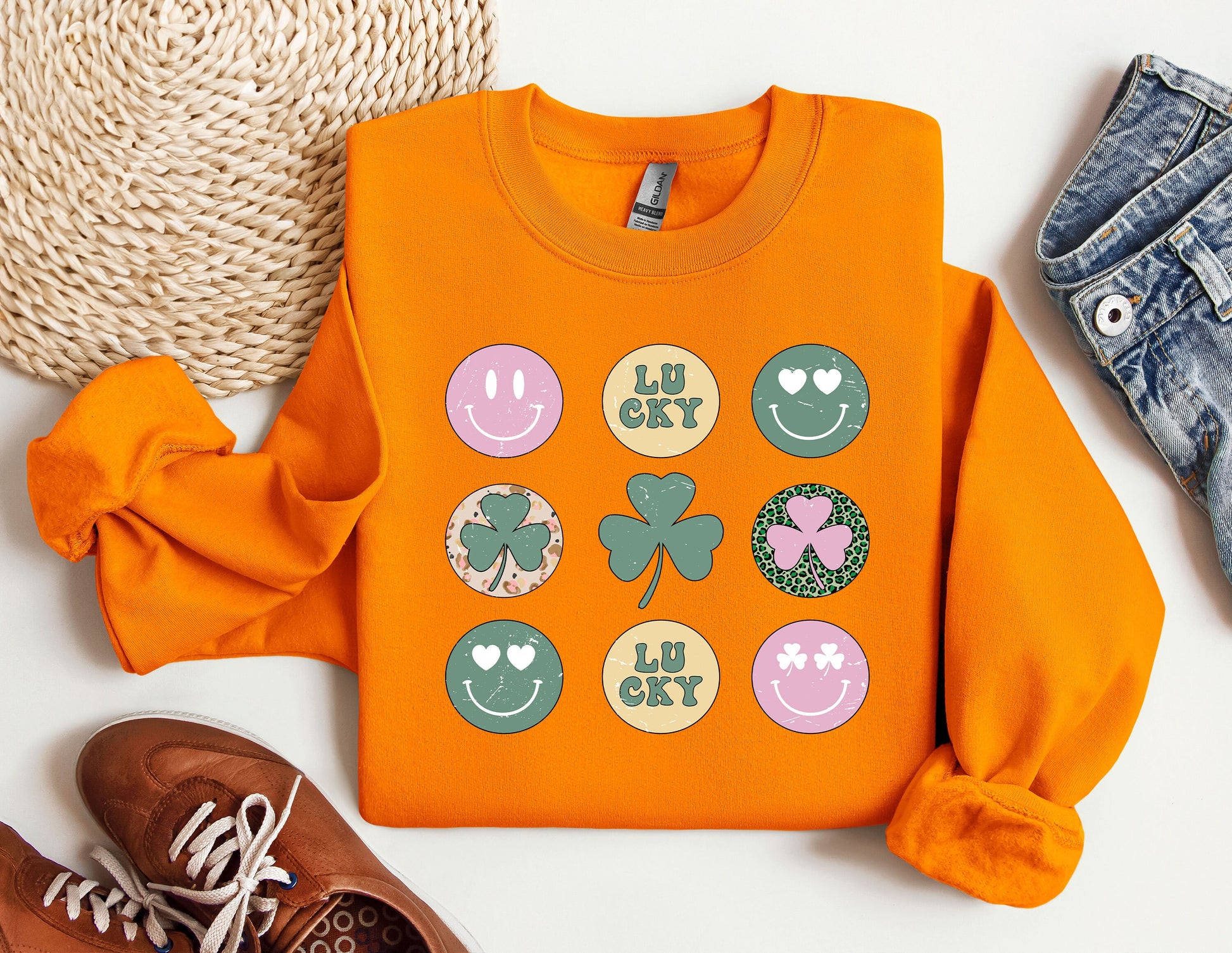 a pair of shoes and an orange shirt with shamrocks on it
