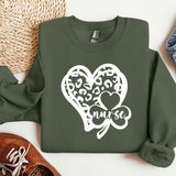 a green sweatshirt with a heart and a shamrock on it