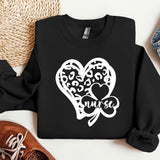 a black sweatshirt with a heart and a shamrock on it