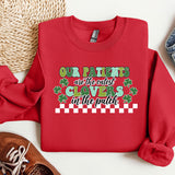 a red sweater with a message on it next to a pair of shoes