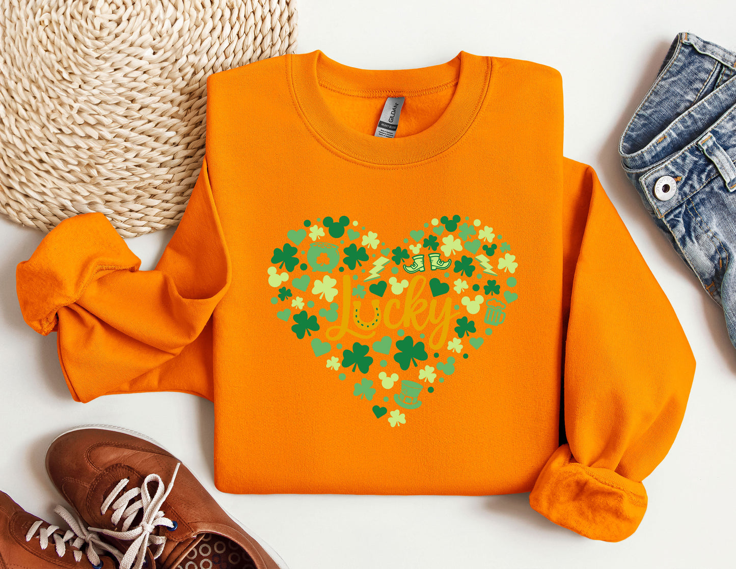 an orange sweater with a shamrock heart on it