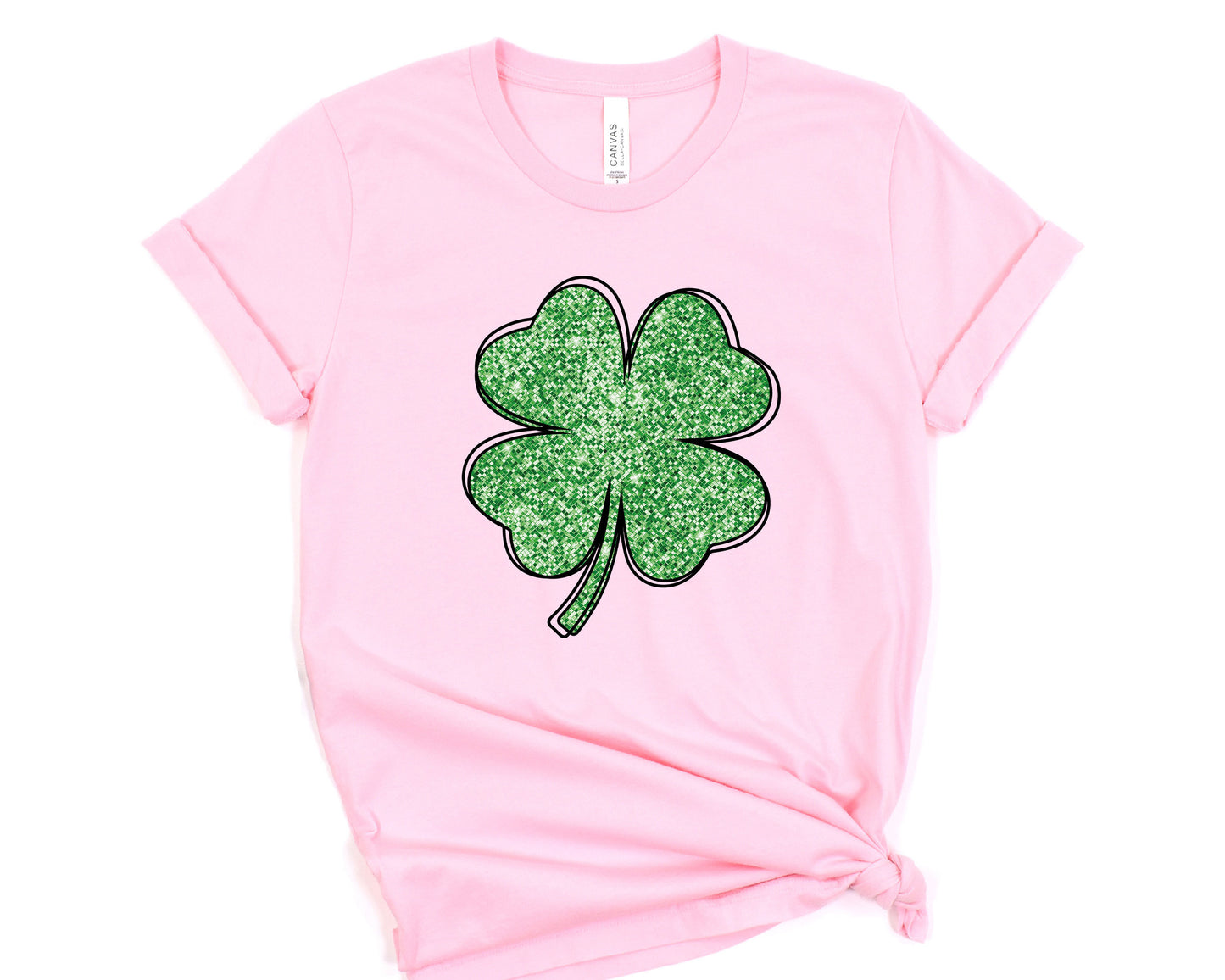 a pink t - shirt with a four leaf clover on it