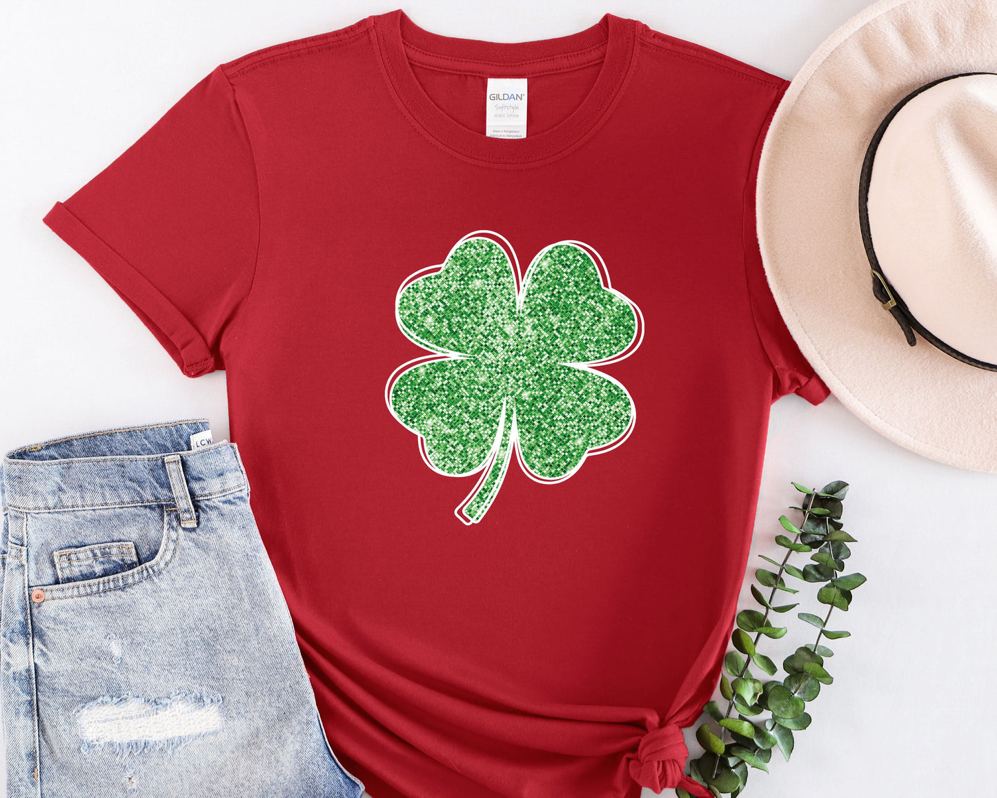 a red shirt with a green shamrock on it